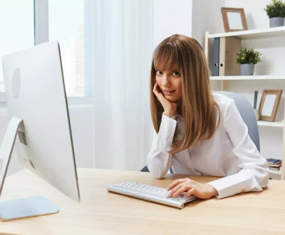cute blonde girl working on the laptop