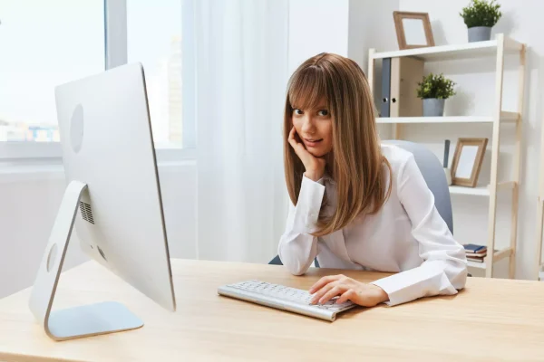 cute blonde girl working on the laptop